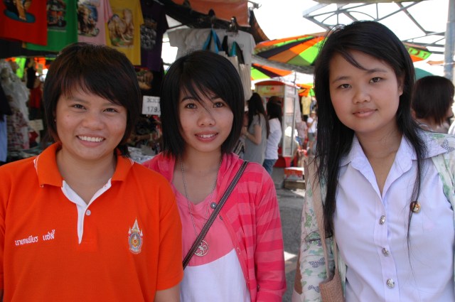 Three young students practise their English skills by interviewing foreigners. Photo Briar Jensen.